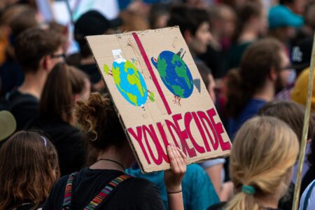 Young climate protester holds up placard with the message 'you decide'. Image: Dominic Wunderlich / Pixabay.