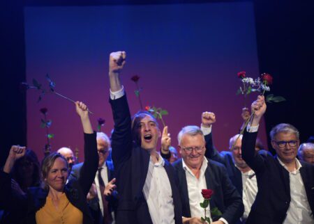 Raphaël Glucksmann (pictured second from left) raises his fist during a European election campaign rally, flanked by PES Common Candidate Nicolas Schmit (second from right) and PS France leader Olivier Faure (right).